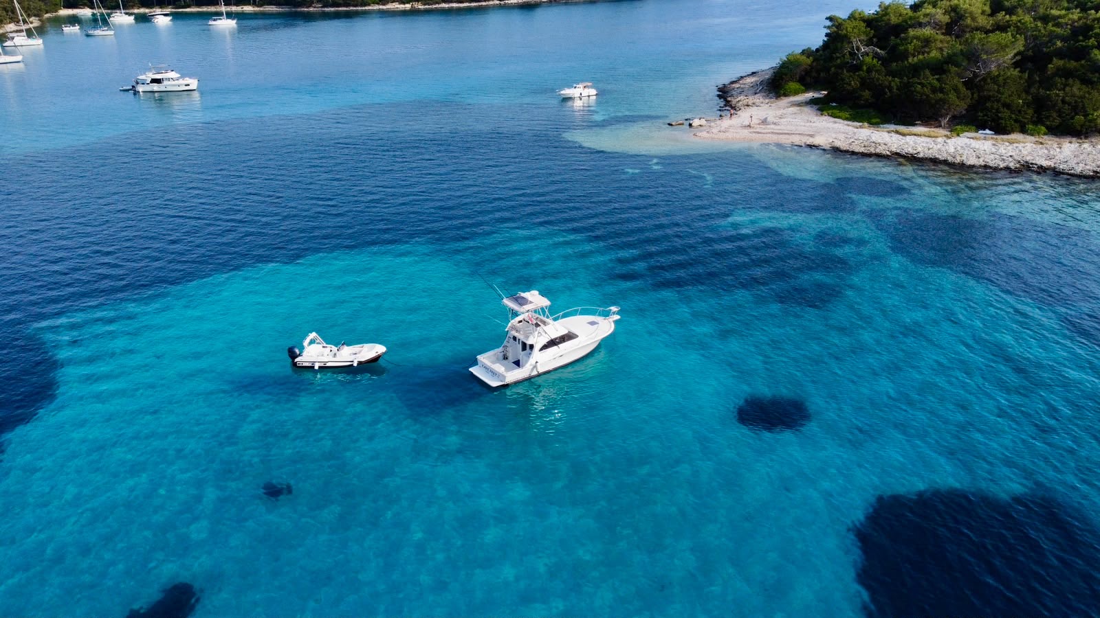 Boats anchored in turquoise water off Ilovik