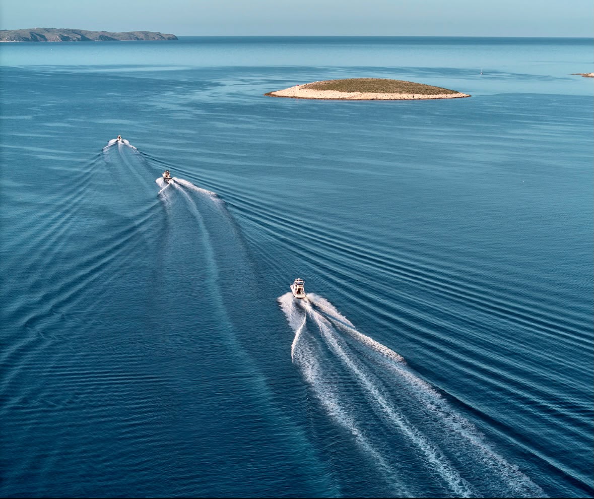 Aerial view of gulet and speedboats near a Croatian islet